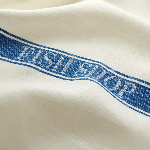 white traditional tea towel with blue Fish Shop logo on a blue band